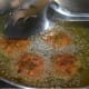 Step four: Deep-fry them on a medium high heat till they are dark brown. Transfer them to a plate with an absorbent paper towel to get rid of the excess oil.