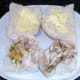 Chicken thigh meat arranged on buttered rolls