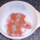 Seasonings are scattered over chicken thighs