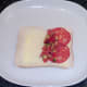 Starting to assemble chorizo and salsa on bread