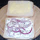 Onion and chive cottage cheese and red onion strands on bread
