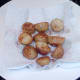 Drained roasties are spiced and seasoned