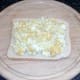 Mashed egg is spread on bread