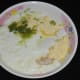 Step two: Add gram flour, yogurt, water, hing powder, ginger-green chili paste, turmeric powder, and salt in a bowl.