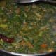 Step seven: Add two cups of water. Stir well. Cook till the veggies become soft and combine well. Simmer until the curry attains a soft texture. Add remaining salt. Mix well. Turn off the stove.