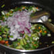 Step three: Add chopped onions. Continue sauteing till they turn translucent.