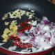 Step one: Saute onions, ginger, garlic, and dry red chilies in oil or butter as per instructions.
