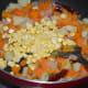 Step five: Throw in fresh corn kernels. Continue stir-cooking for two more minutes.
