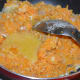 Step six: Add remaining ghee. Continue stir-cooking until the mix becomes almost dry and comes out like a lump, leaving ghee on the edges.