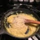 Add beaten egg yolks and Parmesan cheese to the sauce.