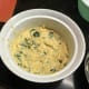 Add the sauce to the souffle dish, followed by a layer of spinach, then more sauce and Parmesan cheese.