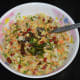 Step four: Pour the tempering on the salad. Mix well. Serve 3–4 tablespoons of the salad in a bowl. Enjoy munching this crunchy, sweet, and spicy salad!