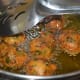 Step four: Fry in medium-hot oil till they become golden brown. Transfer the cooked fritters to a paper towel. Repeat the same for making all the fritters.