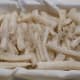 Wrap the salted radish batons in a tea towel for fermentation.