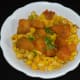 Step seven: Add this corn equally into two bowls. Top them each with half portion of cooked spicy potatoes. Garnish it with finely chopped green coriander leaves.