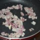 Step two: Heat oil in a pan. Saute chopped onions till they get golden brown.