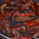 Step two: In the same pan, dry saute red chilies till they become a bit crispy. Add it to the plate.