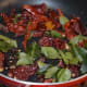 Step four: Saute broken red chili, curry leaves, and hing/asafoetida in very little oil till they become crispy.