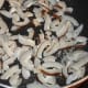 Step two: In the same pan, saute dry coconut slices till they become crispy. Collect them in a plate.