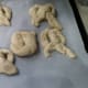 lay flat on parchment paper. You will not bake with the paper, just use while raising and coating with egg wash