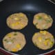 Step five: Heat a griddle or pan. Add some oil or butter. Place a few of the patties on it. Add a few drops of oil on the edges and on the top.