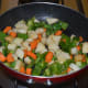 Step six: Add remaining oil to the same pan. Saute the veggies for 3 minutes.