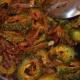 Step seven: Continue stir-cooking on low heat until bitter gourd becomes almost dry. Add tamarind pulp or lemon juice. Continue cooking for a while to blend it with the contents in the pan.