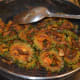 Continuing to cook the dish.