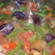 Boil the mix while stirring occasionally. Cover the cooker and cook till you hear one whistle.