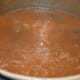 Step six: Add turmeric powder, sambar powder, tamarind paste or juice, remaining salt, jaggery powder, coconut powder, and hing powder. Bring the mix to a good boil. Simmer for a minute. Turn off the heat.