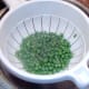 Drained peas are seasoned