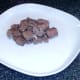 Steak and venison sausage is spooned on to serving plates