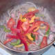 Sliced peppers are added to sauteed onion and bacon