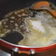 Step two: Add sugar. Stir well. Let it melt and become golden brown.