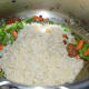 Step five: Throw in soaked rice. Continue stir-cooking for another 3 minutes.