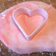 Creating a heart out of a colored marzipan with the use of a heart cookie cutter.