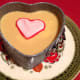 Ready to be eaten mango dessert, decorated with a marzipan heart.