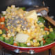 Step four: Also, add pepper powder. Stir cook for 3-4 minutes or until the veggies and corn become soft yet retain some crunch.