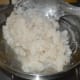Step six: Don't allow it to become too dry. At this point, turn off the heat. Transfer it to a greased plate.