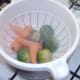 Sprouts and carrots are drained and set aside to cool