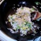 Light soy sauce is sprinkled over stir frying rice