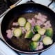 Sauteing halved sprouts and bacon