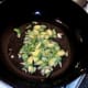 Sliced brussels sprouts are added to wok