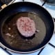 Burger is turned to fry on second side