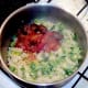 Meatballs in salsa are added to pasta and sprouts