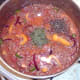 Seasonings are added to tomatoes and beef combination