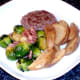 Plated burger, sprouts, bacon and wedges