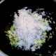 Cooled rice is added to stir fried sprouts