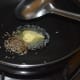 Step four: Heat butter in a deep-bottomed pan. Add cumin seeds. Let them sizzle.