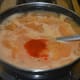 Step eight: Add two cups of water, sugar, remaining salt, and red chili powder.